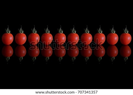 Japanese red cherry tomato on black