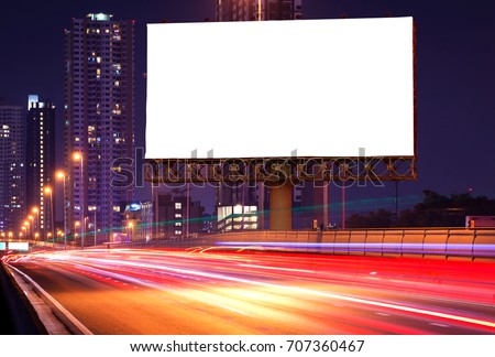 Blank billboard on light trails, street and urban in the night - can advertisement for display or montage product or business. Royalty-Free Stock Photo #707360467
