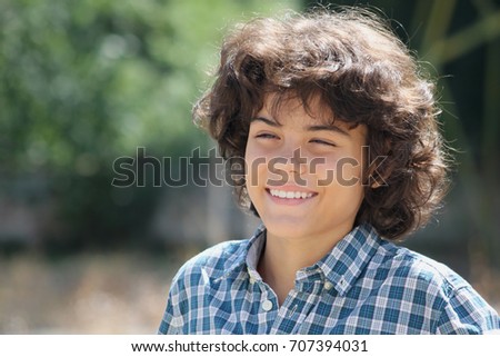 An outdoor portrait of an attractive teenage boy, facial expressions