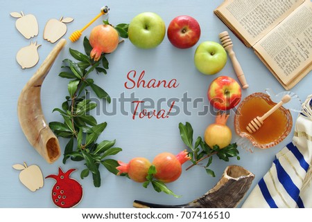 Rosh hashanah (jewish New Year holiday) concept. Traditional symbols. Text SHANA TOVA means HAPPY NEW YEAR in hebrew