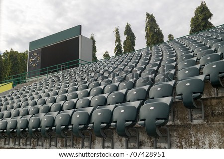 outdoor folding stadium seat with scoreboard background