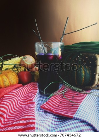 Halloween dark purple special drink mixed with grape juice, purple eggplant, lemon, still life picture with selective focus in old vintage color decoration