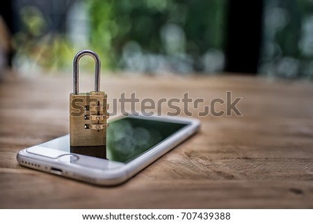 Smartphone with an locked lock on it. Mobile phone security and data protection concept High Dynamic Range tone Royalty-Free Stock Photo #707439388