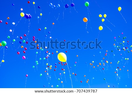 Colorful balloons against a blue sky