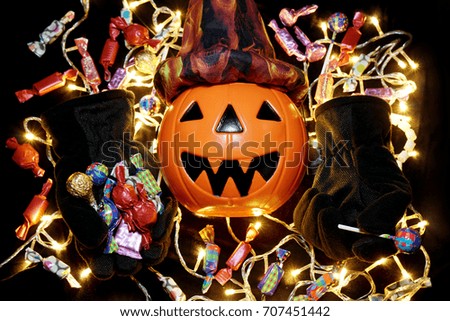 Halloween pumpkin face with candy and electric light
