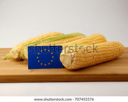 EU flag on a wooden panel with corn isolated on a white background