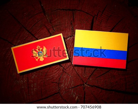 Montenegrin flag with Colombian flag on a tree stump isolated