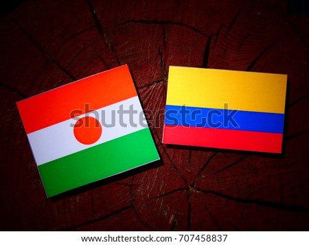 Niger flag with Colombian flag on a tree stump isolated