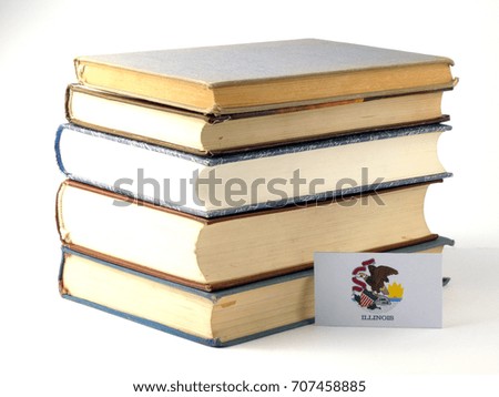 Illinois flag with pile of books isolated on white background
