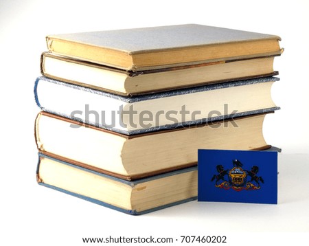 Pennsylvania flag with pile of books isolated on white background