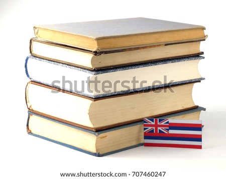 Hawaii flag with pile of books isolated on white background