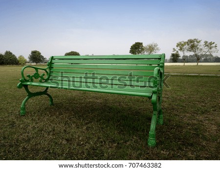 Close up of a Green Bench in park 