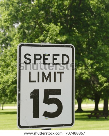 The black and white speed limit sign on a close up view.