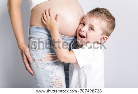 Young boy with the pregnant woman isolated on white background