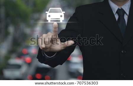 Businessman pressing car flat icon over blur of rush hour with cars and road, Business transportation service concept