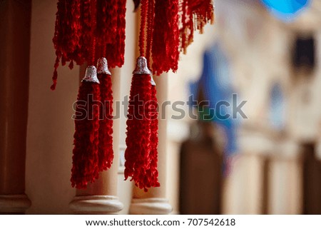 Textile decorations hanging inside Indian temple macro.