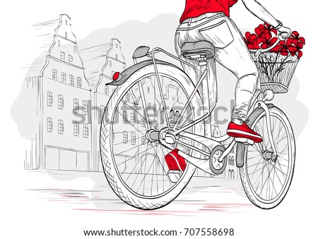 Bicyclist girl in red on city background