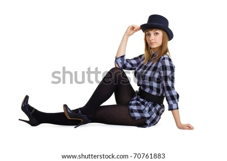 attractive girl in a hat sitting on the floor. Studio photography