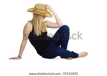 attractive girl in the wicker hat sitting on the floor on a white background