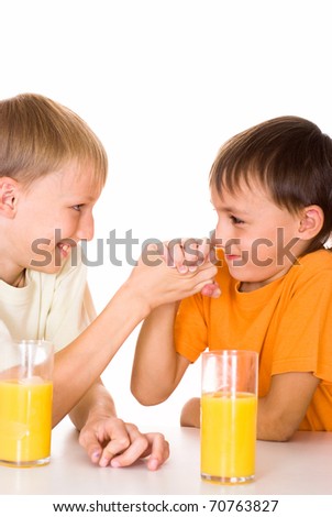 two brothers drink juice on a white