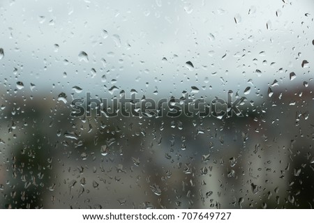 Rain drops on the glass overlooking the residential area