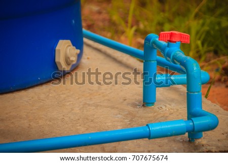 Red knob of PVC ball valve on the PVC pipe line in plumbing system for control the water to storage tank. Royalty-Free Stock Photo #707675674