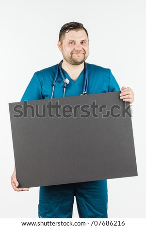 Young doctor holding a blank banner in the hands of copy space for your text. on a white background.