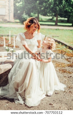Happy family. Young beautiful mother and her daughter having fun in the park. Positive human emotions, feelings
