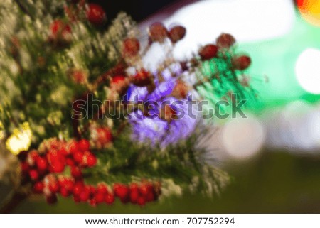 Blurred Christmas background with fir branch and colorful bokeh