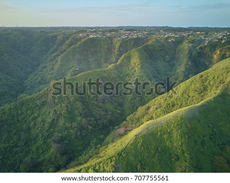 Village in green mountain hills on sunset orange light in Nicaragua