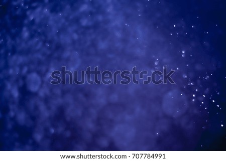 bokeh of water fly and lights on blue background