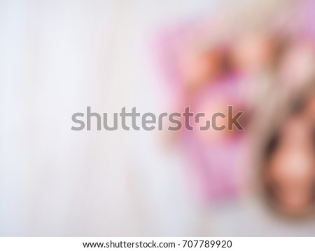 Blur picture of Many eggs in wood bowl on white wood background for cooking