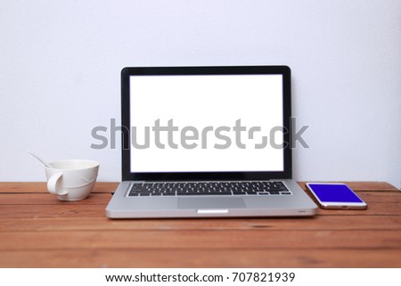 Laptop on wooden table notebook smatpone  and coffce