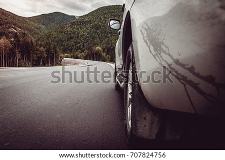 gray SUV on the edge of an asphalt road