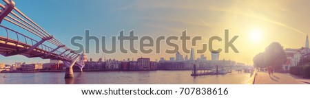 London, panoramic view over Thames river with Millennium bridge, St. Paul and London skyline on a bright sunny morning. Toned image.