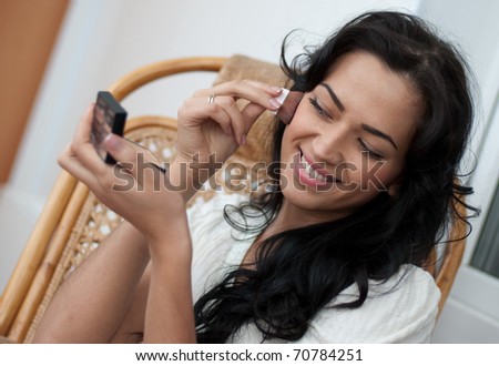 Girl doing makeup close up