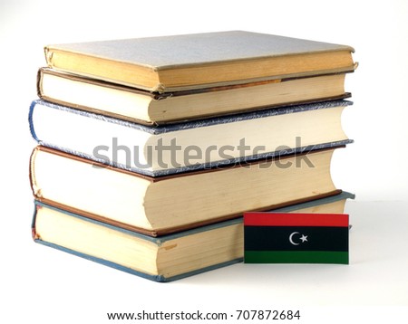 Libyan flag with pile of books isolated on white background