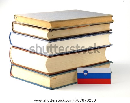 Slovenian flag with pile of books isolated on white background