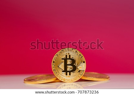 Gold Bitcoin on the red background. Concept mining