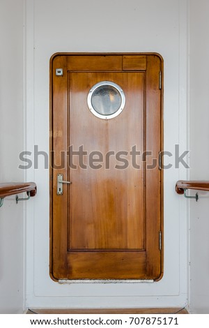 Old wooden narrow door on vintage ship. Direct view, vertical crop