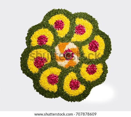 Flower Rangoli for Diwali or Pongal Festival made using Marigold or Zendu flowers and Rose petals over white background, selective focus