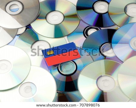 Liechtenstein flag on top of CD and DVD pile isolated on white