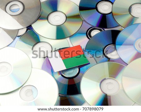 Madagascar flag on top of CD and DVD pile isolated on white