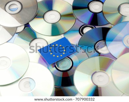 EU flag on top of CD and DVD pile isolated on white