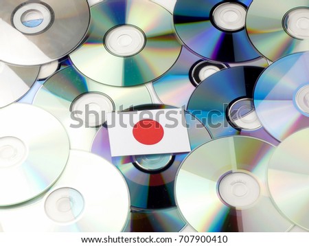 Japanese flag on top of CD and DVD pile isolated on white