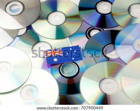 Australian flag on top of CD and DVD pile isolated on white