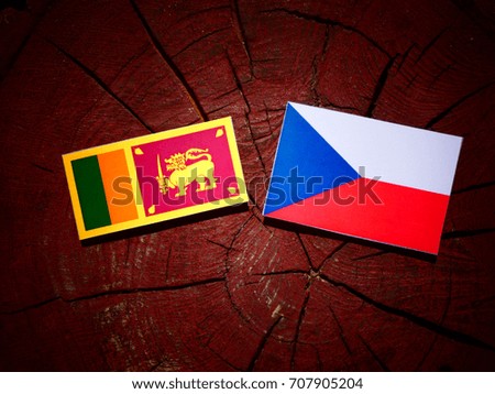 Sri Lankan flag with Czech flag on a tree stump isolated