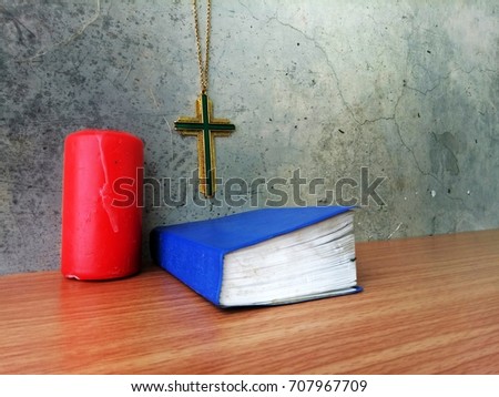 Still life items in Christ church, cross with bible and candle, on grunge vintage background