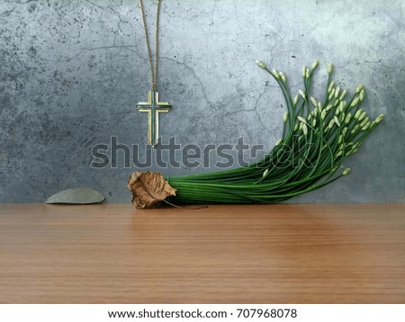 Still life Christ cross necklace with decorative natural plant on grunge vintage background
