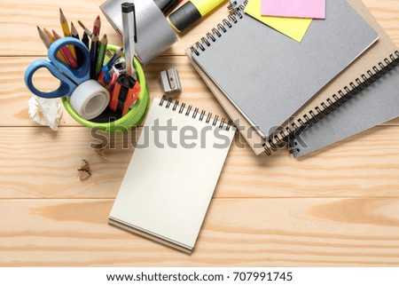 School stationery and office supplies on wooden table, space for text. view from above